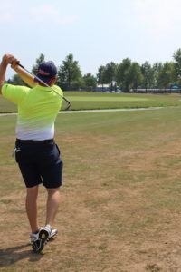 Photo of a golfer in the middle of a backswing.