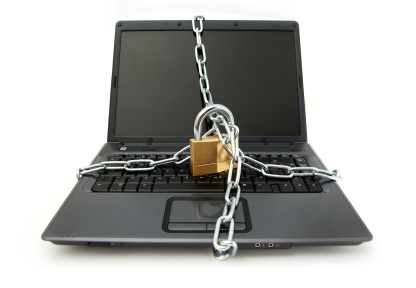 Photo of a laptop with chains and a lock