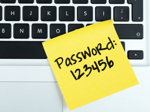 Photo of a post-it note on a laptop keyboard that says "Password: 123456"
