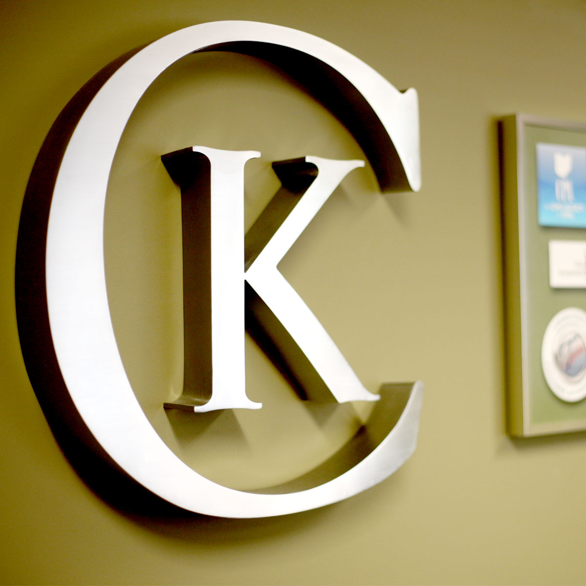 Photo of a 3D logo of the letters CK, the abbreviated form of the Corrigan Krause Logo